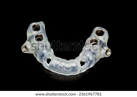 navigational surgical template for dental implantation operations isolated closeup on a black background Royalty-Free Stock Photo #2361967781