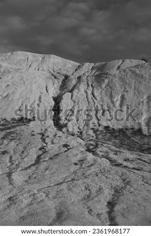 abstract painting on a chalk hill, black and white photo, natural background.