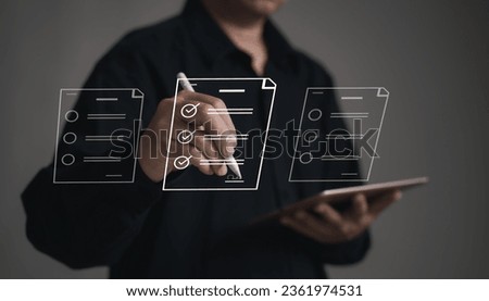 Concepts of practices and policies Company articles association forTerms and Conditions : Businessman using stylus pen to select electronic document on a digital document in a virtual screen to read. Royalty-Free Stock Photo #2361974531