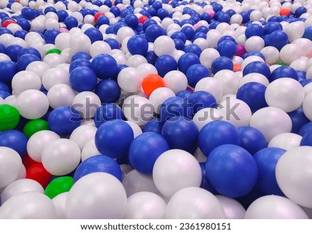 colorful plastic balls on children's playground. Colorful plastic balls in children's playroom, closeup of photo