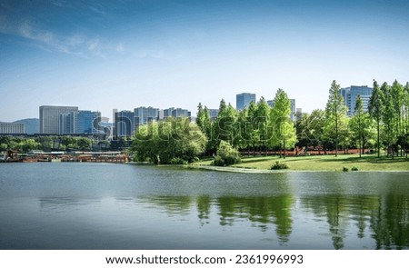 Nice city park by the lake Royalty-Free Stock Photo #2361996993