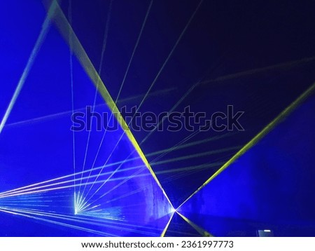 The stage lights and lasers are dancing in the company of a light haze.