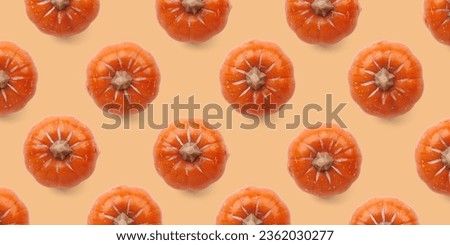 Orange pumpkin pattern on pastel color background. Halloween pumpkin background. Autumn concept.