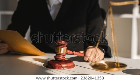 Lawyer female working with hammer and scales with document, contract, legal adviser concept.