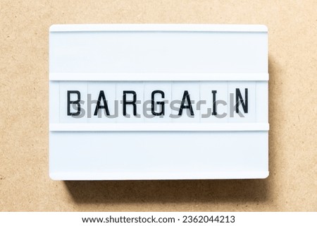 Lightbox with word bargain on wood background