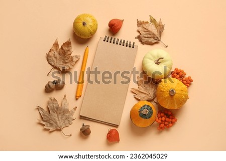 Composition with blank notebook, pen, pumpkins and natural forest decor on color background
