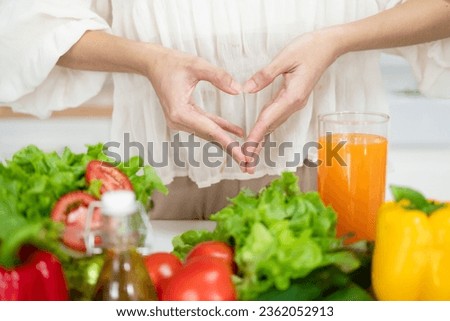 Female make shape of heart with her hands. Light summer breakfast with organic vegetable, fruits. Nutrition that promotes good digestion and functioning of gastrointestinal tract. Royalty-Free Stock Photo #2362052913