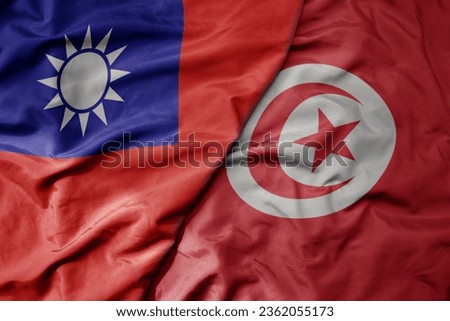 big waving national colorful flag of taiwan and national flag of tunisia . macro