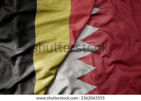 big waving national colorful flag of belgium and national flag of bahrain . macro