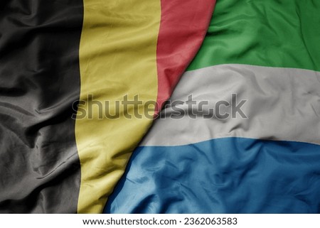 big waving national colorful flag of belgium and national flag of sierra leone . macro