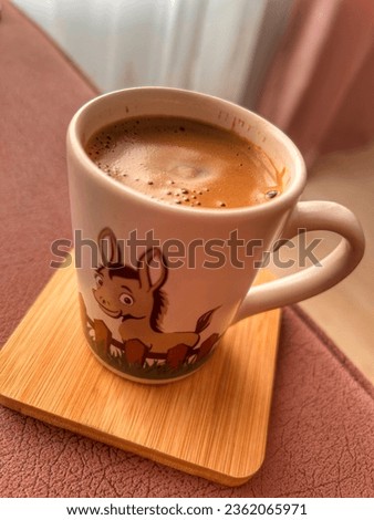 Greek coffee in a mug with the image of a donkey.
