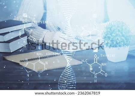 DNA theme hologram over woman's hands writing background. Concept of education. Double exposure