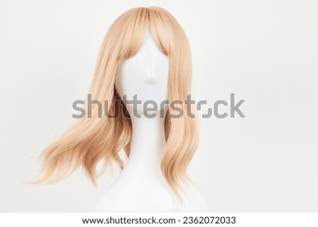 Natural looking blonde fair wig on white mannequin head. Middle length hair cut on the plastic wig holder isolated on white background, front view
 Royalty-Free Stock Photo #2362072033