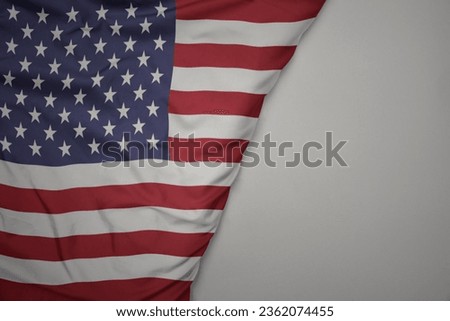 big waving national colorful flag of united states of america on the gray background. macro