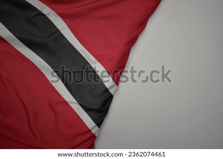 big waving national colorful flag of trinidad and tobago on the gray background. macro