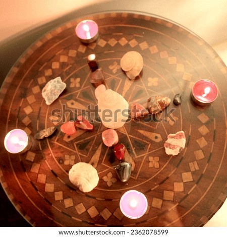 Sacred geometry with stones selenite and red candles on a wooden table Royalty-Free Stock Photo #2362078599