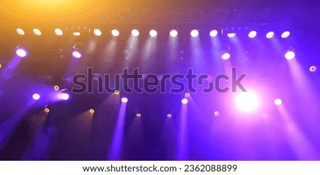 glowing purple atmospheric abstract background of concert spotlights with light and Mist during the show or concert