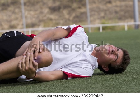 Footballer faking an injury Royalty-Free Stock Photo #236209462