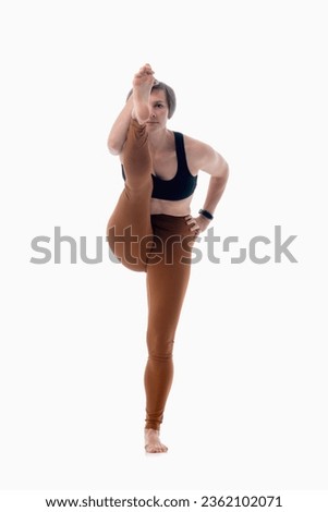 Utthita hasta padangusthasana (Extended hand to big toe pose), Ashtanga yoga  Woman wearing sportswear doing Yoga exercise against white background.  Royalty-Free Stock Photo #2362102071