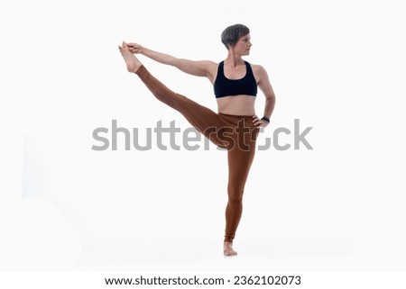 Utthita hasta padangusthasana (Extended hand to big toe pose 2), Ashtanga yoga  Woman wearing sportswear doing Yoga exercise against white background.  Royalty-Free Stock Photo #2362102073