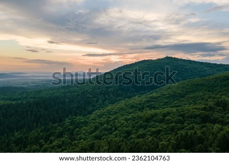 Aerial view of green pine forest with dark spruce trees covering mountain hills. Nothern woodland scenery from above Royalty-Free Stock Photo #2362104763