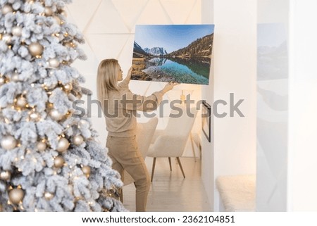 woman holding photo canvas at christmas