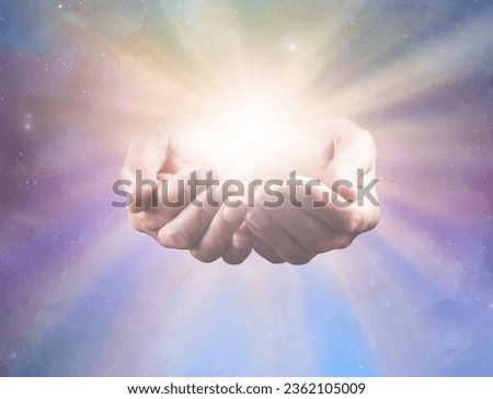 Connect with Divine Intelligence - and All That Is - mature male healers cupped hands with bright healing star light radiating outwards against celestial background ideal for a spiritual holistic heal