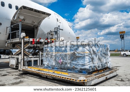 Air cargo logistic containers are loading to an airplane. Air transport shipment prepare for loading to modern freighter jet aircraft at the airport. Royalty-Free Stock Photo #2362125601