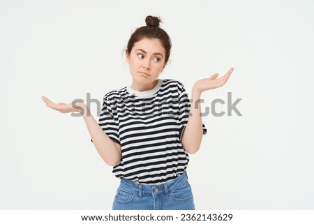 I dont know. Clueless young woman shrugging shoulders, looks confused, stands against white studio background. Royalty-Free Stock Photo #2362143629