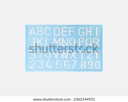 Light blue alphabet stencil lettering PVC plastic ruler template isolated on white background