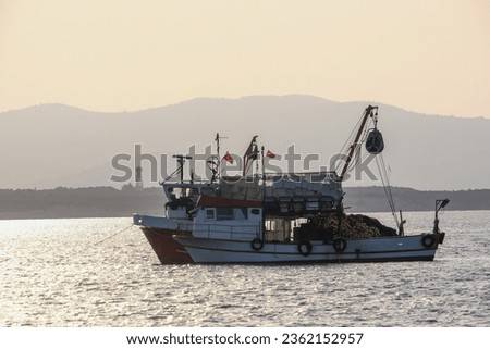 Fish boat with fisher net on the sea in the morning with sky background. 