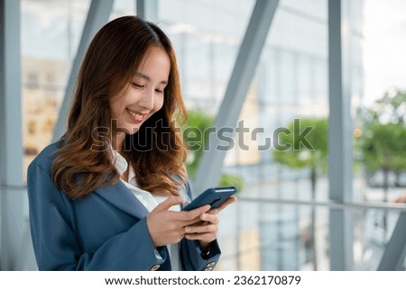 Close-up image of young woman using modern smartphone device for messaging and browsing social media apps, lifestyle woman working