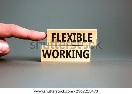 Flexible working symbol. Concept words Flexible working on beautiful wooden blocks. Beautiful grey table grey background. Businessman hand. Business flexible working concept. Copy space. Royalty-Free Stock Photo #2362213493