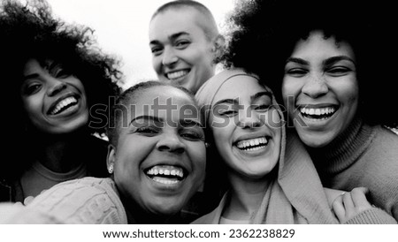 Happy group of multiracial women having fun outdoors - Real people from different ethnicity celebrating outdoors - Lifestyle and youth culture concept - Black and white editing Royalty-Free Stock Photo #2362238829