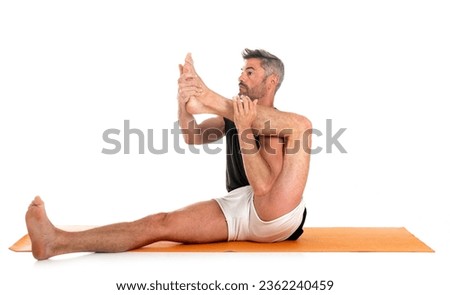 man and hatha yoga asana in front of white background