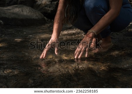 a woman doing yoga poses by the river