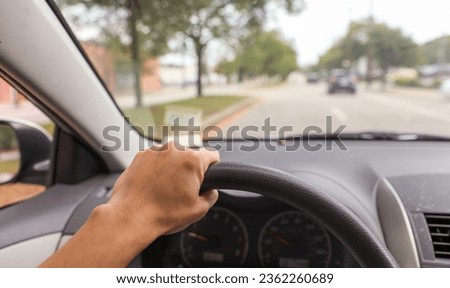 hand grips a car steering wheel, symbolizing safe and controlled driving, with a focus on responsibility and road safety Royalty-Free Stock Photo #2362260689