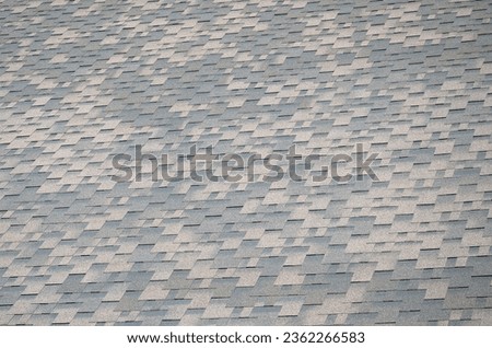 Flexible shingles of bitumen roofing surface. Background mosaic texture of flat roof tiles with bituminous coating Royalty-Free Stock Photo #2362266583