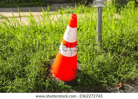 orange construction cone on a road, symbolizing safety, caution, and ongoing work at a construction site