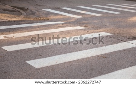 urban crosswalk with colorful lines, symbolizing pedestrian safety and city connectivity