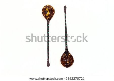 antique spoon in front of white background