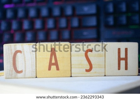 Photo of wooden blocks that make up the vocabulary "CASH" in English