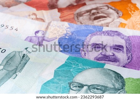 Several Colombian banknotes of different values, close-up photograph, horizontal image