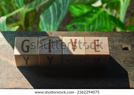 Photo of wooden blocks that make up the vocabulary "GIVE" in English