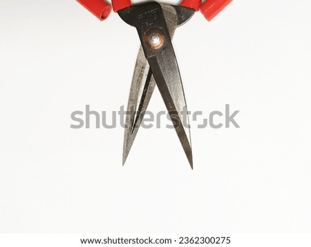 large iron scissors with red handles.  fabric cutting scissors.  background for the textile industry