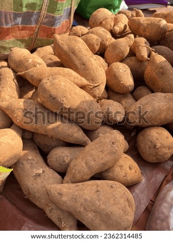 Photographing sweet potatoes sold at the market