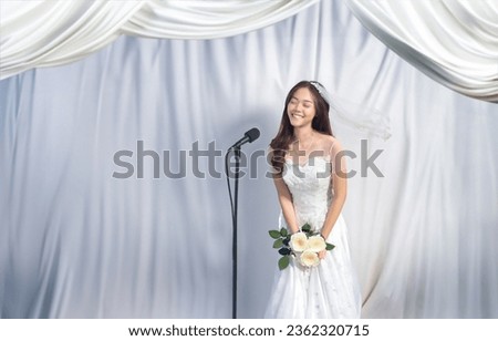asian woman in wedding dress and veil holding rose flower talking moment speach in wedding ceremony by standy microphone on stage