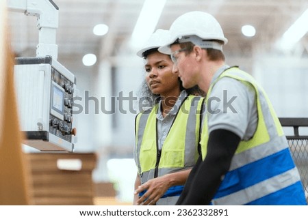 Workers examining printouts at printing plant