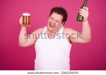 Drunk fat man posing on a pink background. Alcohol and a healthy lifestyle.