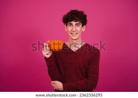 Young attractive student posing on a pink background.